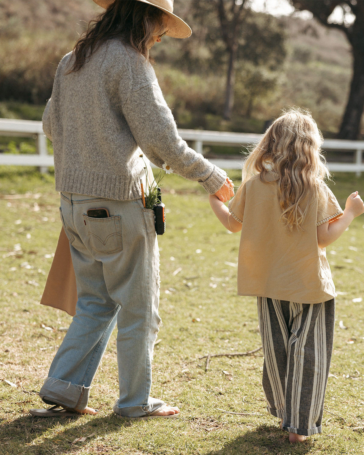 Designer walking with a little girl