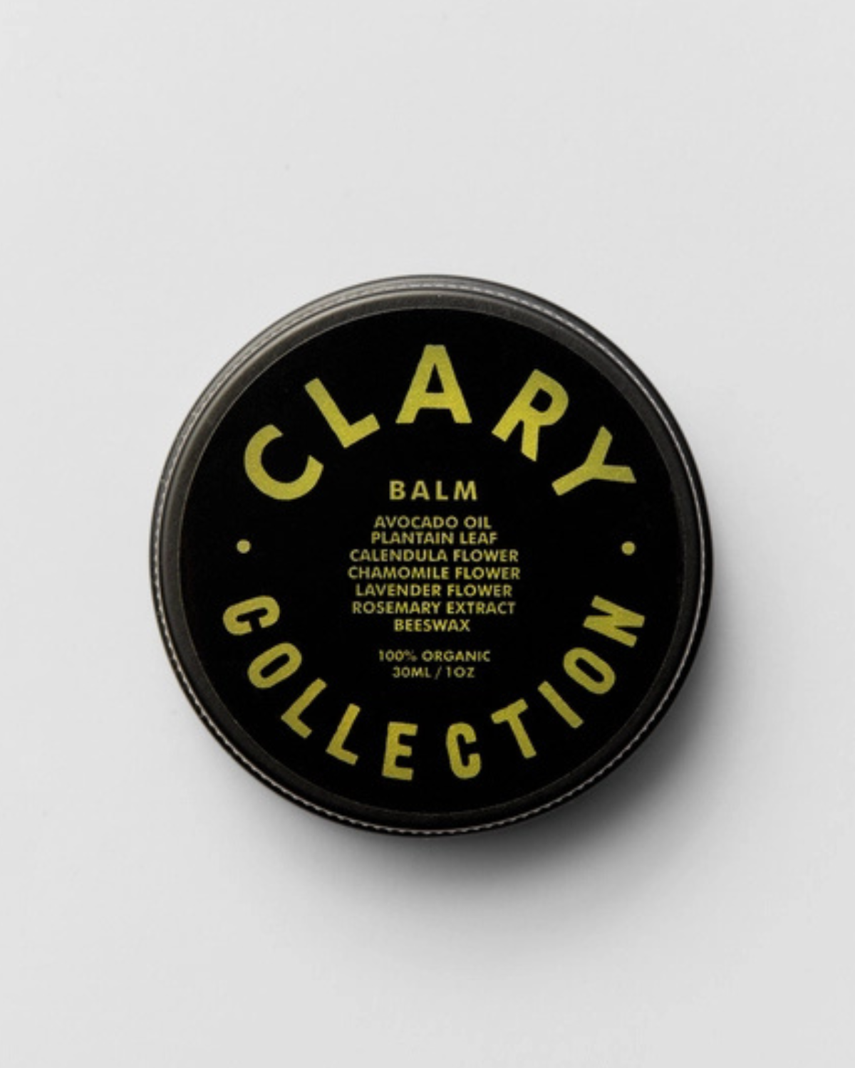 A container of Clary Avocado Balm with black and green labeling, indicating organic ingredients and various floral extracts.