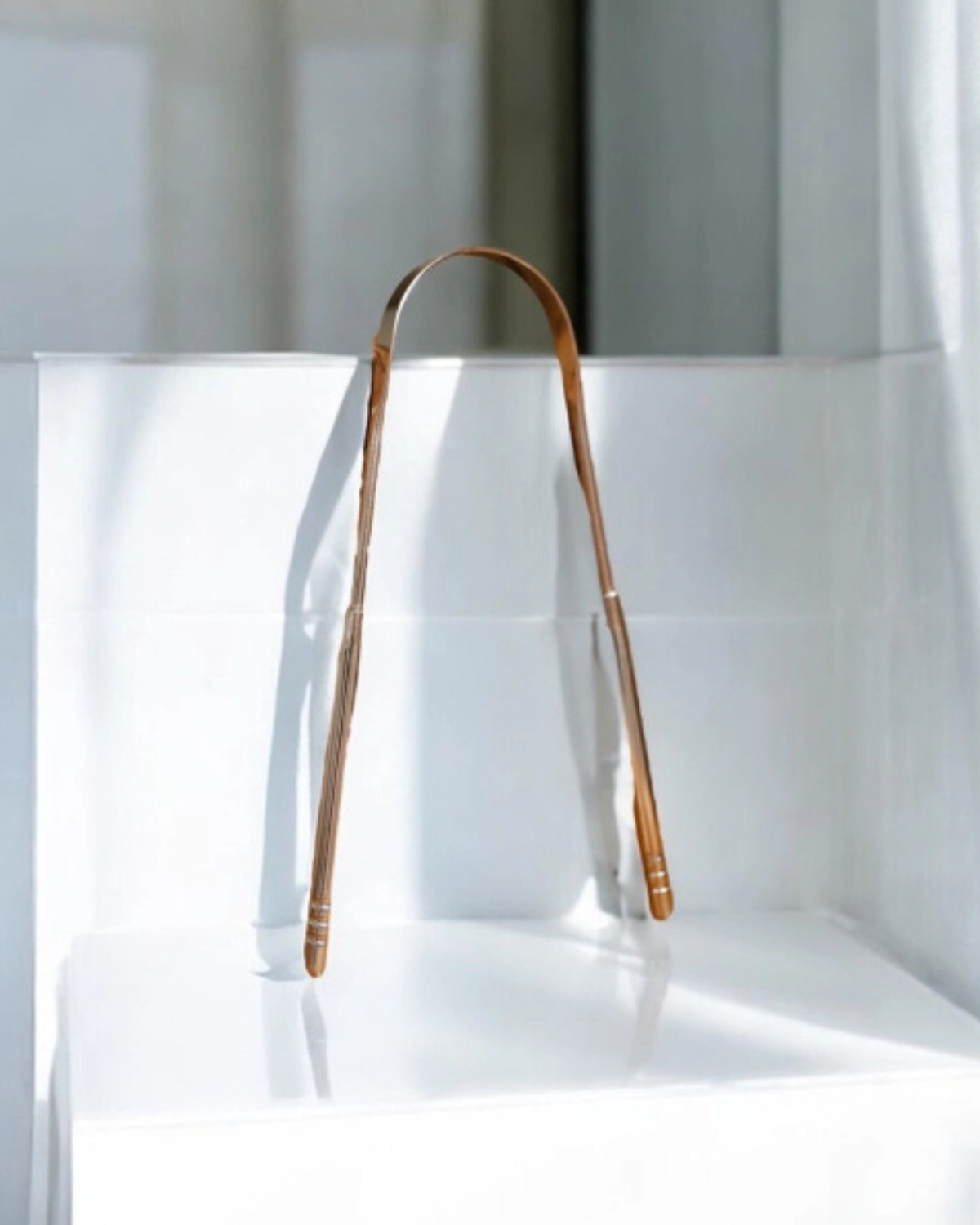 tongue scraper leaning on counter