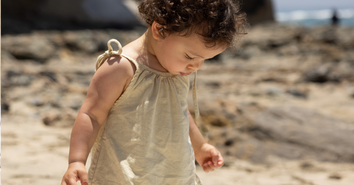 baby girl walking on the beach