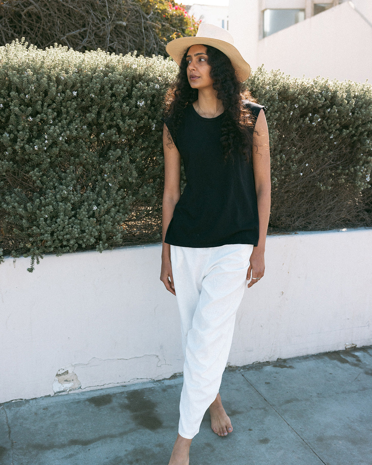 muscle tee and white pants and hat